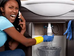 Emergency plumbing repair for a leaking sink drain under a bathroom vanity in Oakland, CA